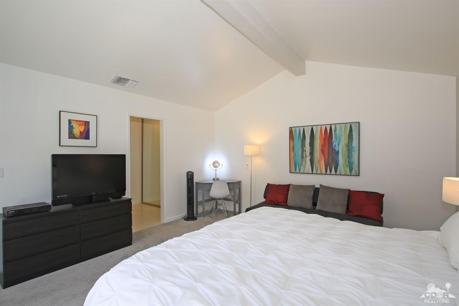 6012 East Driver Road Palm Springs, CA 92264 - Photo 23 of 47 a bedroom with a bed and a flat screen tv
