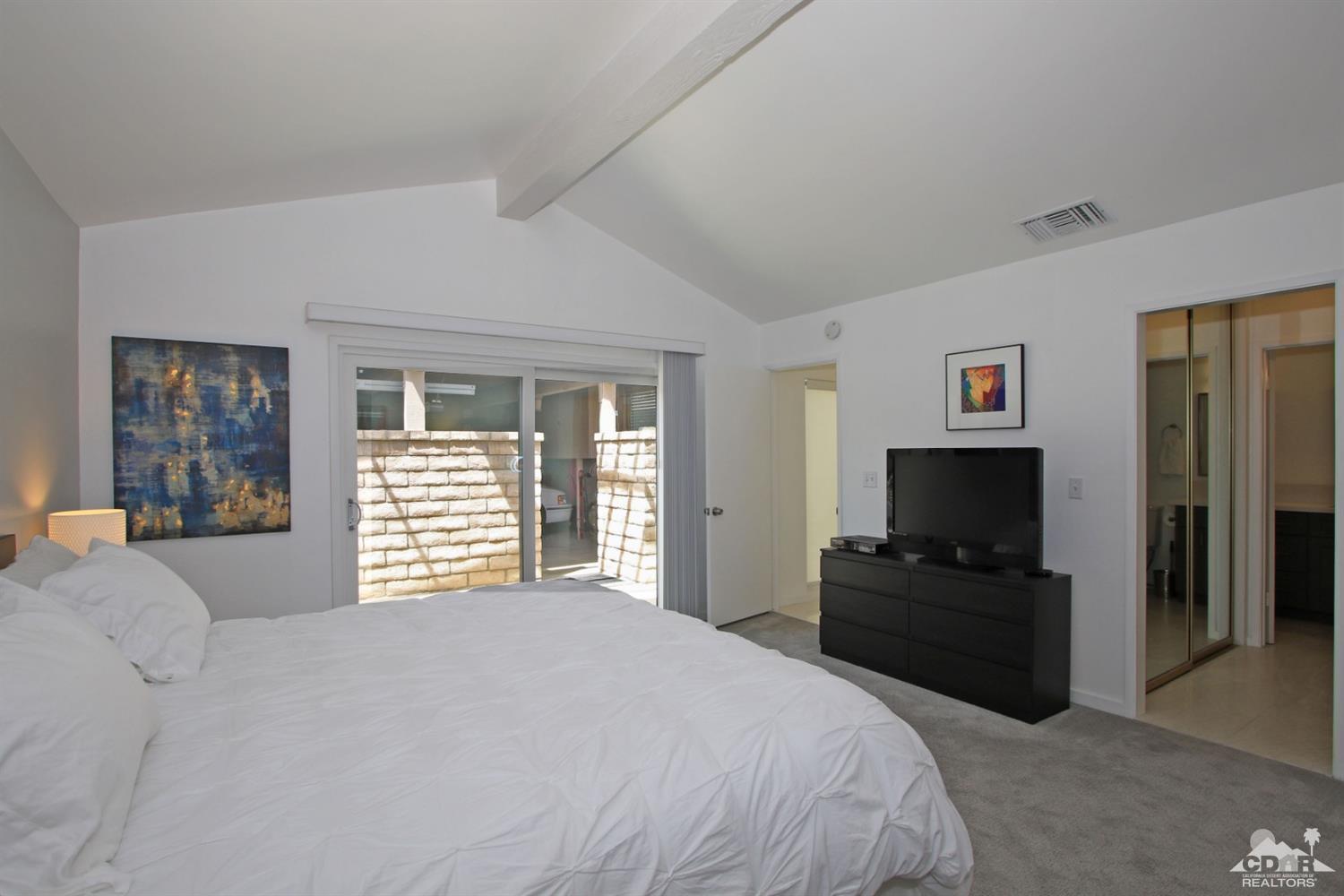6012 East Driver Road Palm Springs, CA 92264 - Photo 24 of 47 a bedroom with a bed and a television in it