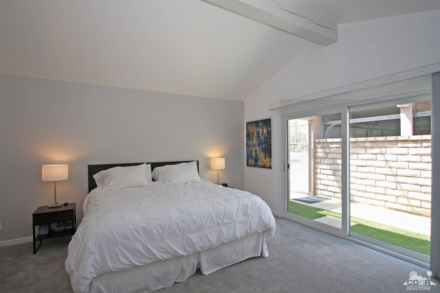 6012 East Driver Road Palm Springs, CA 92264 - Photo 25 of 47 a bedroom with a bed and a lamp next to a window