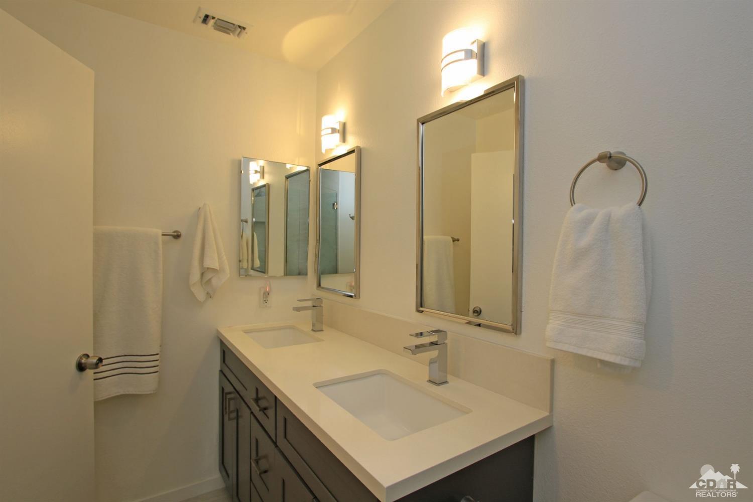 6012 East Driver Road Palm Springs, CA 92264 - Photo 27 of 47 a bathroom with a sink and a mirror