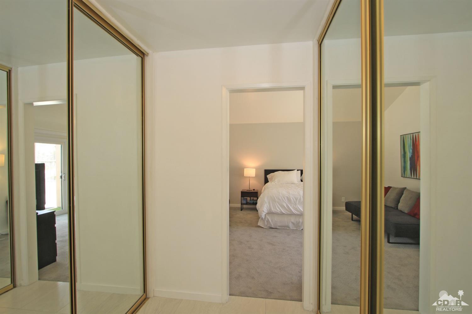 6012 East Driver Road Palm Springs, CA 92264 - Photo 28 of 47 a bathroom with a glass shower door and mirror