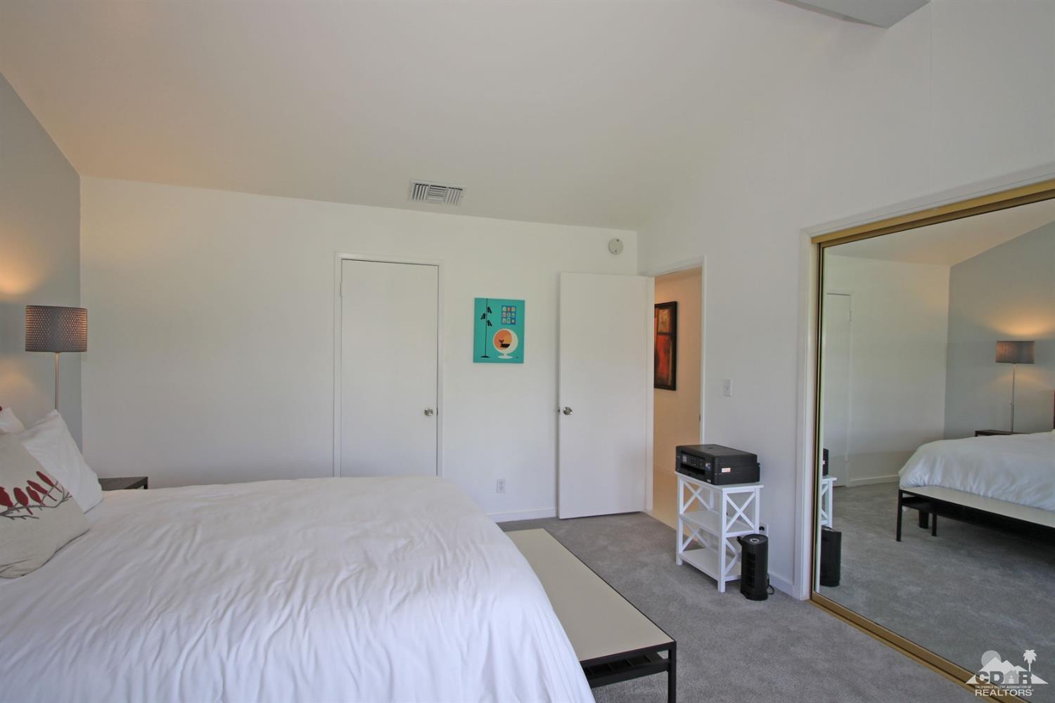 6012 East Driver Road Palm Springs, CA 92264 - Photo 31 of 47 a bedroom with a bed and a mirror