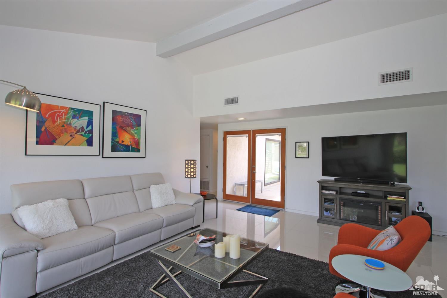 6012 East Driver Road Palm Springs, CA 92264 - Photo 9 of 47 a living room with furniture a flat screen tv and a window
