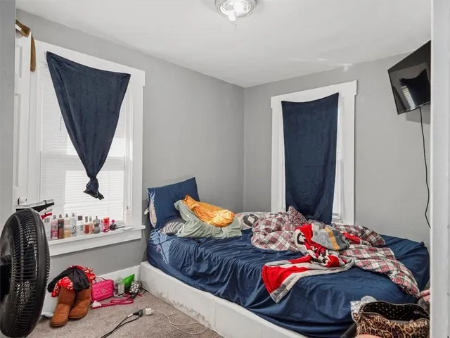 a bedroom with bed and a window