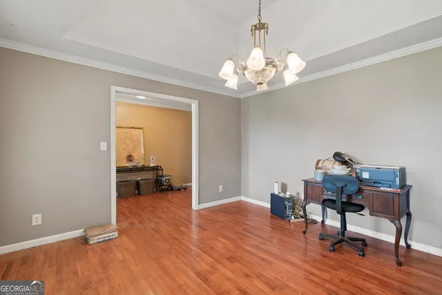 a view of a workspace with furniture and a chandelier