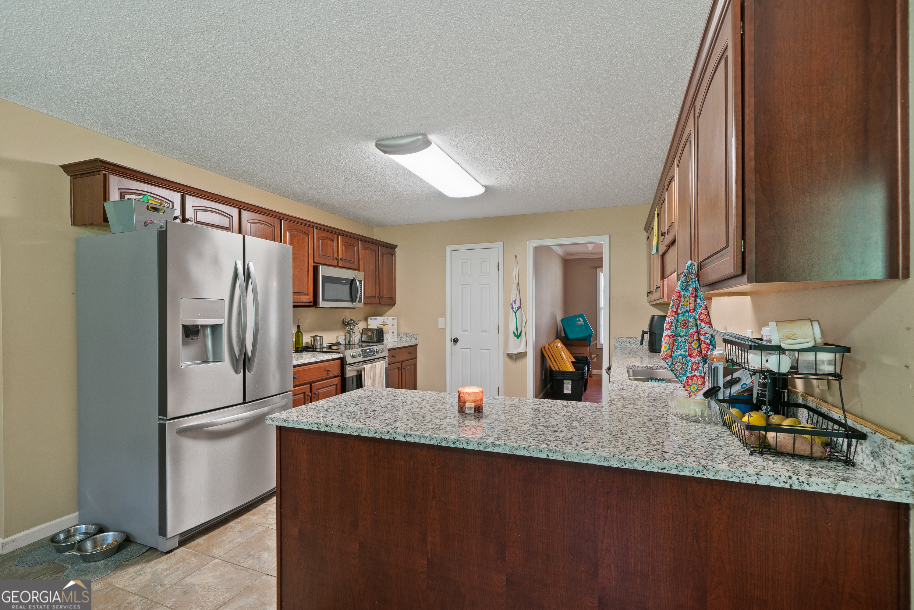 193 Virginia Avenue Gray, GA 31032 - Photo 24 of 48 a kitchen with stainless steel appliances granite countertop a refrigerator and a sink