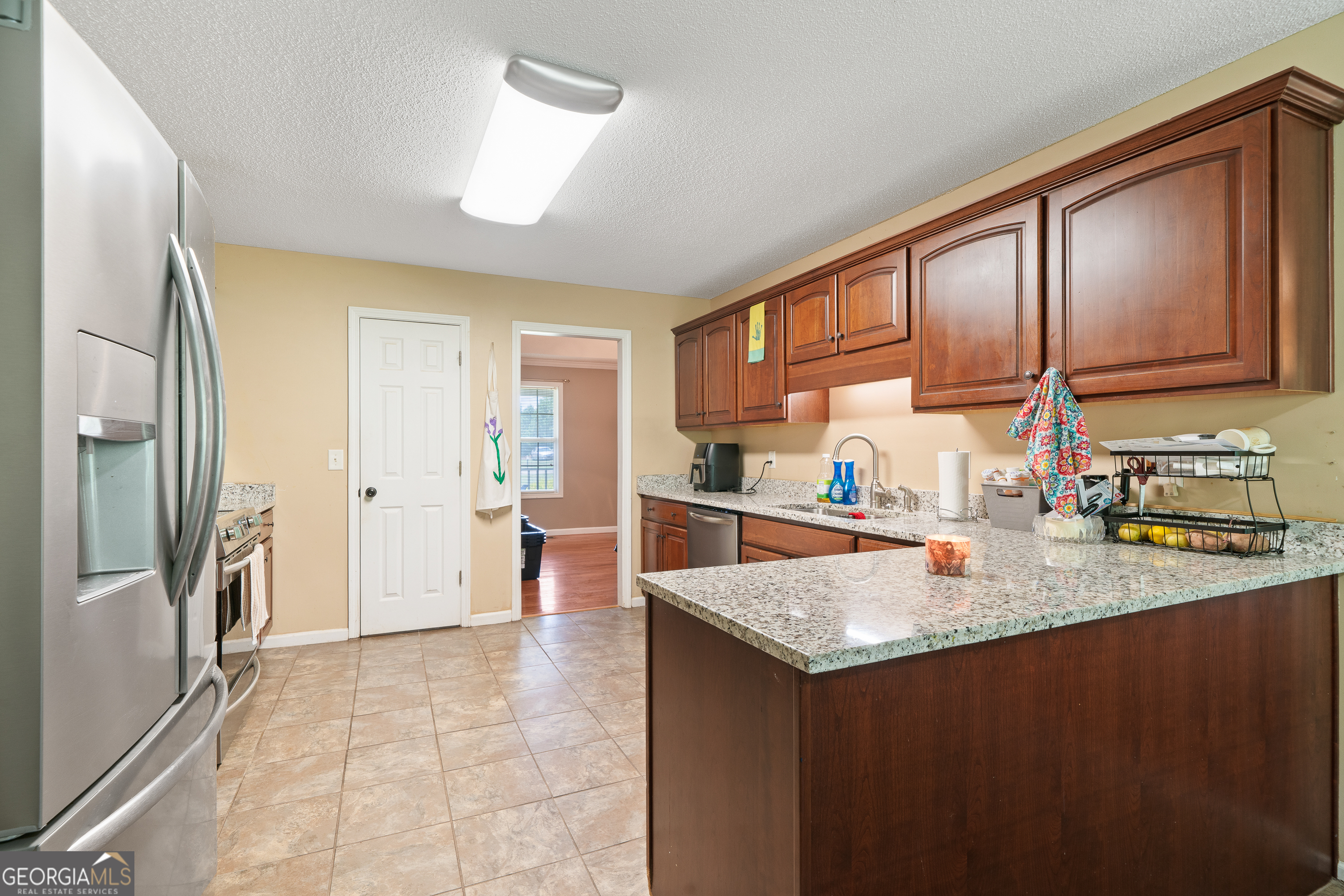 193 Virginia Avenue Gray, GA 31032 - Photo 28 of 48 a kitchen with a refrigerator sink and cabinets