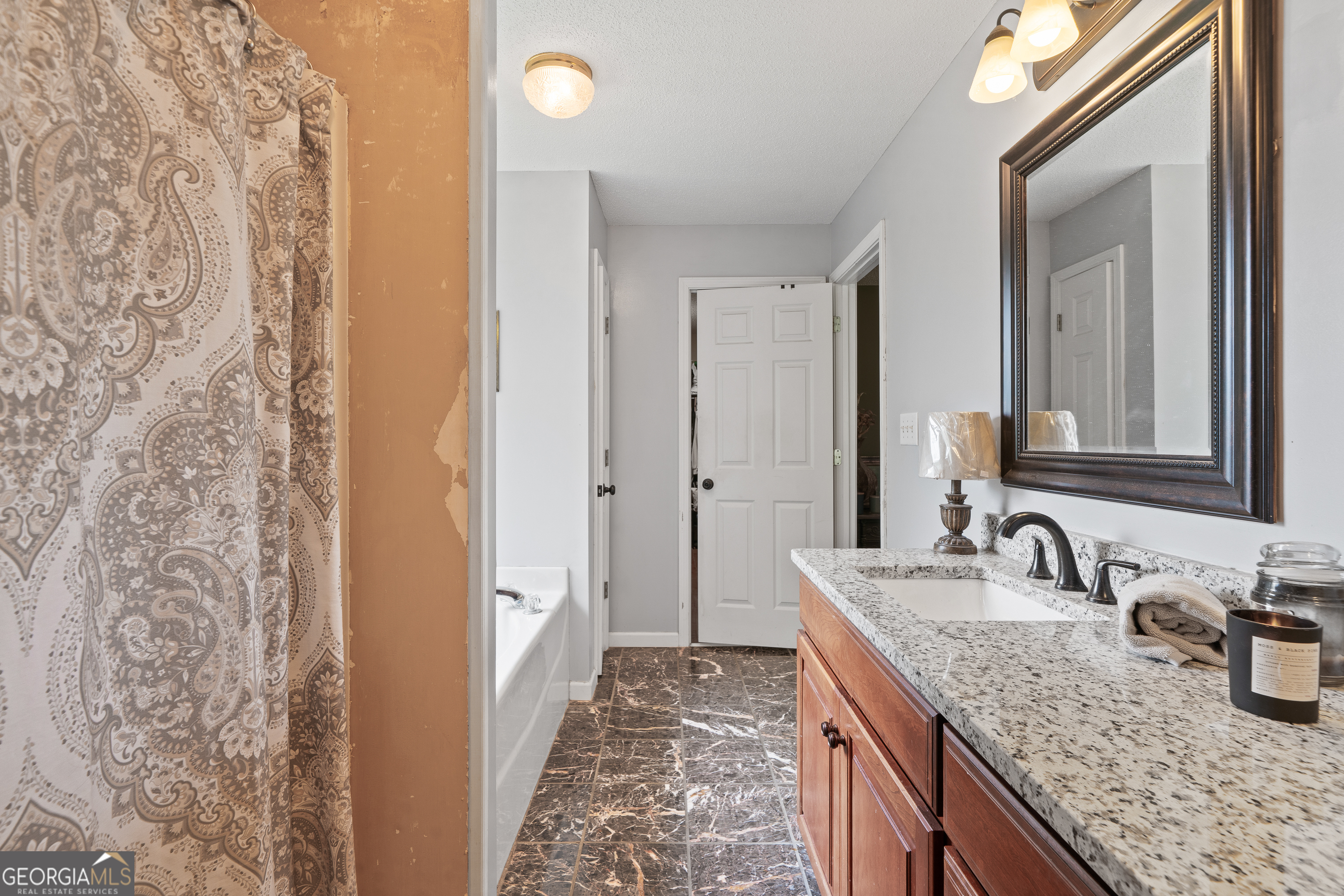 193 Virginia Avenue Gray, GA 31032 - Photo 32 of 48 a bathroom with a granite countertop sink and a mirror