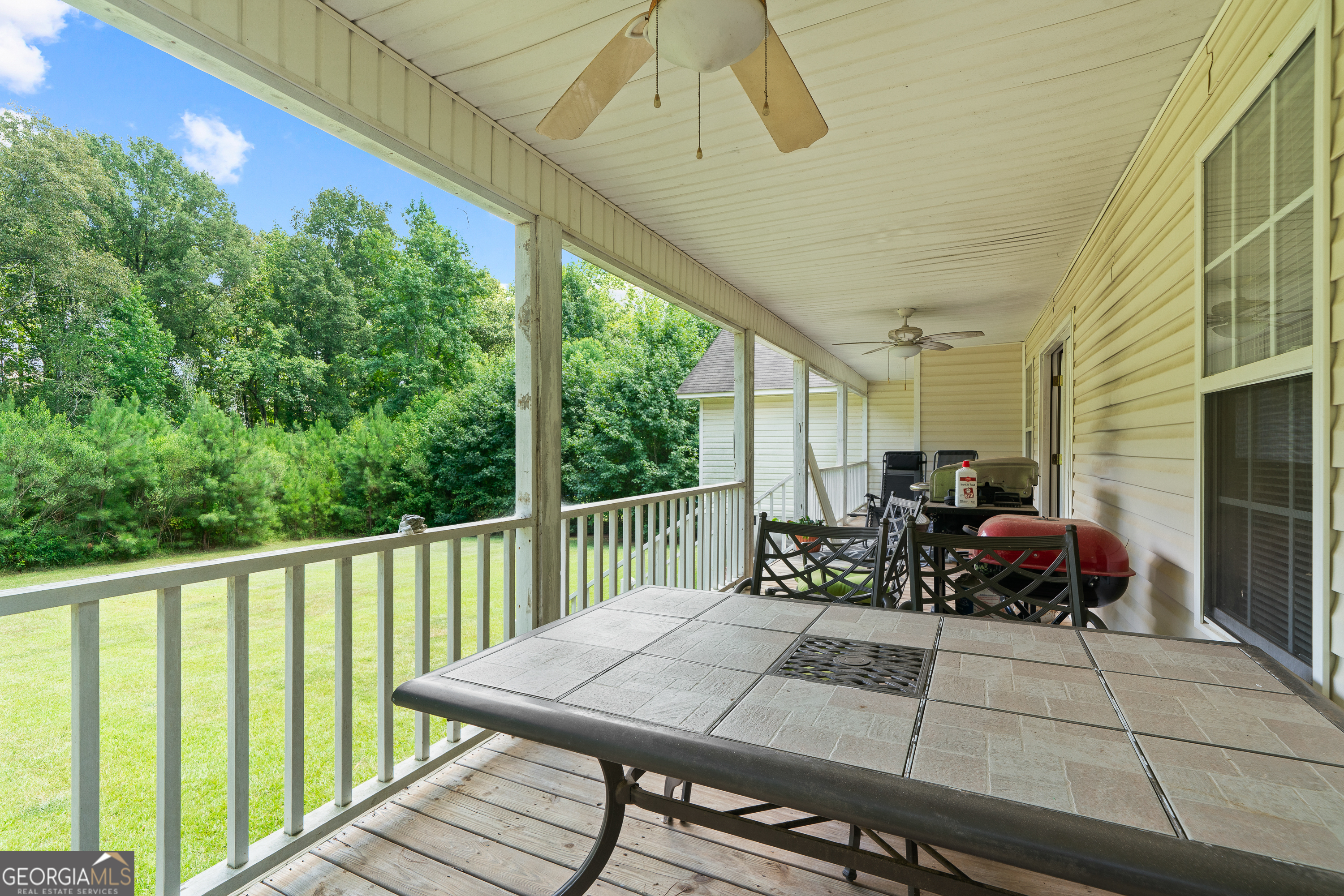 193 Virginia Avenue Gray, GA 31032 - Photo 41 of 48 a view of a patio with table and chairs and wooden floor