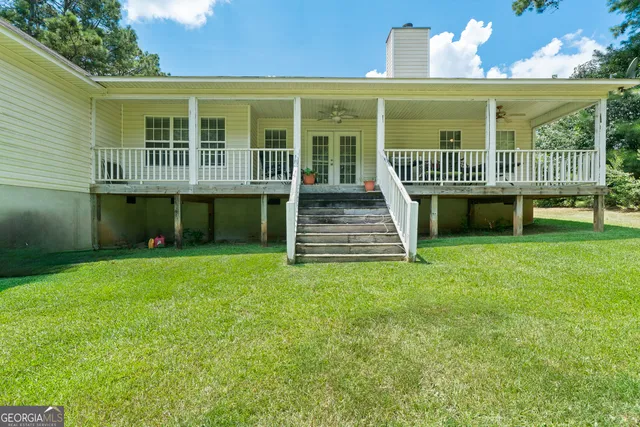 a view of a house with a yard and sitting area