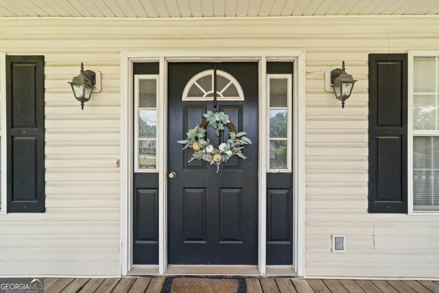a front view of a house with a potted plant