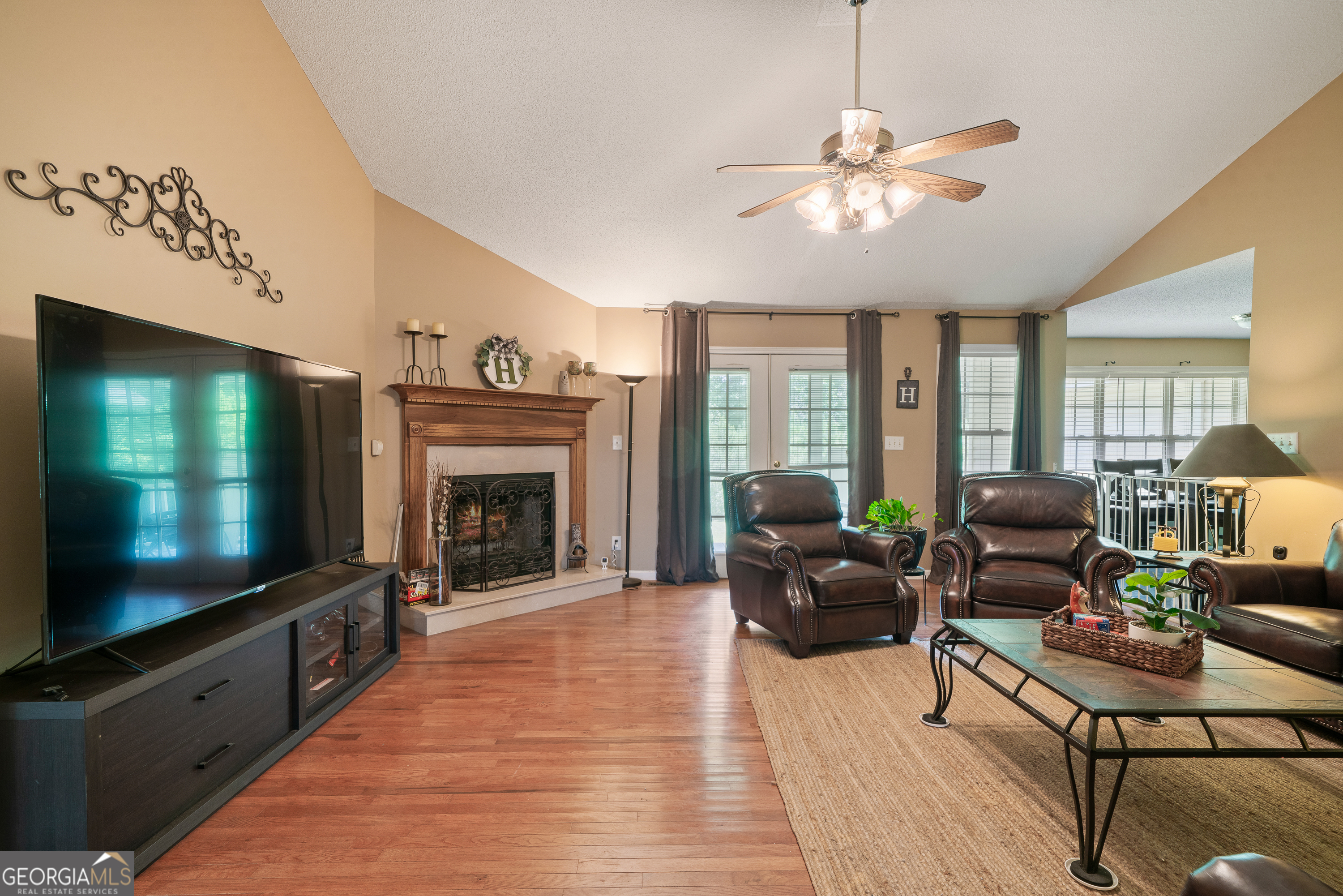 193 Virginia Avenue Gray, GA 31032 - Photo 10 of 48 a living room with furniture a flat screen tv and a fireplace