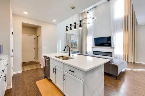 a kitchen with a sink a stove and a refrigerator