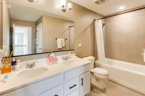 a bathroom with a sink double vanity and a mirror