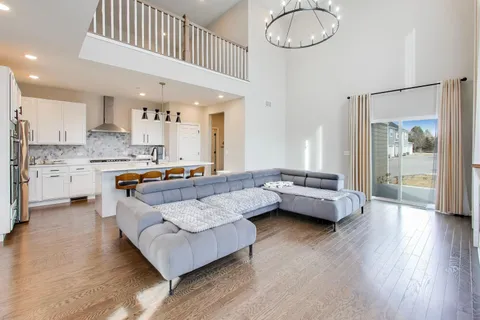 a living room with kitchen island furniture and a wooden floor