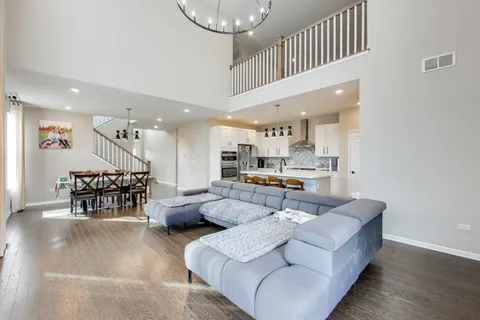 a living room with furniture and kitchen view