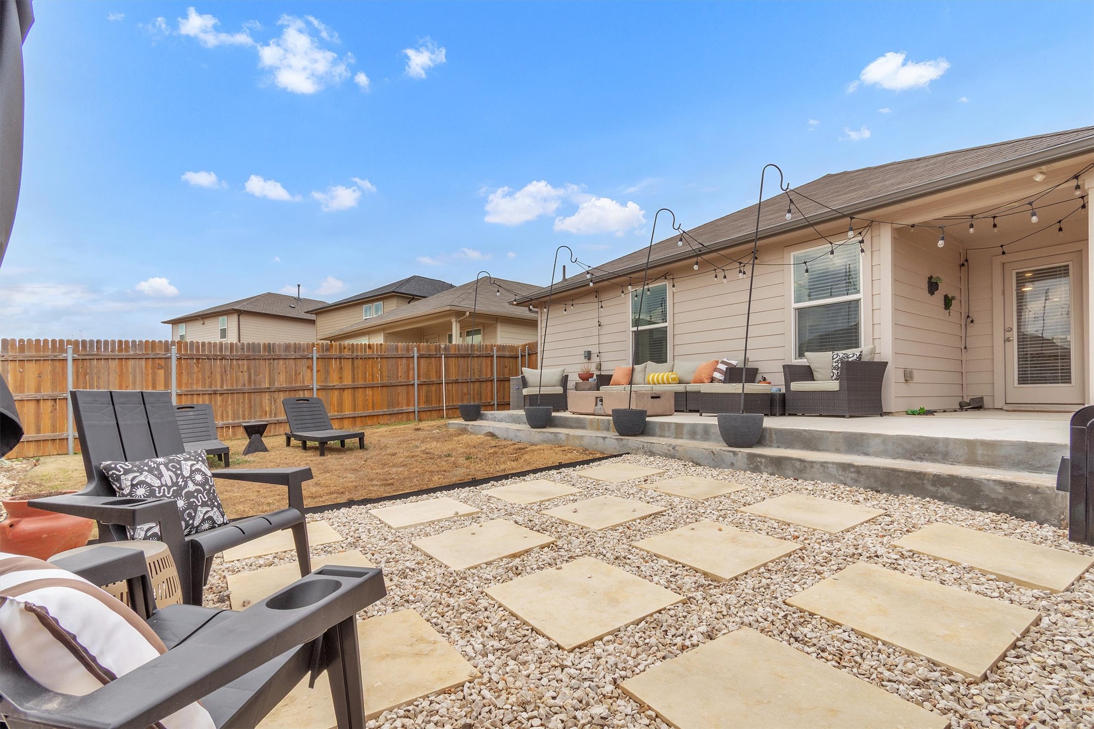 204 Calgary Lane San Marcos, TX 78666 - Photo 21 of 23 Imagine relaxing and entertaining on this spacious extended patio and hardscaped sitting area.