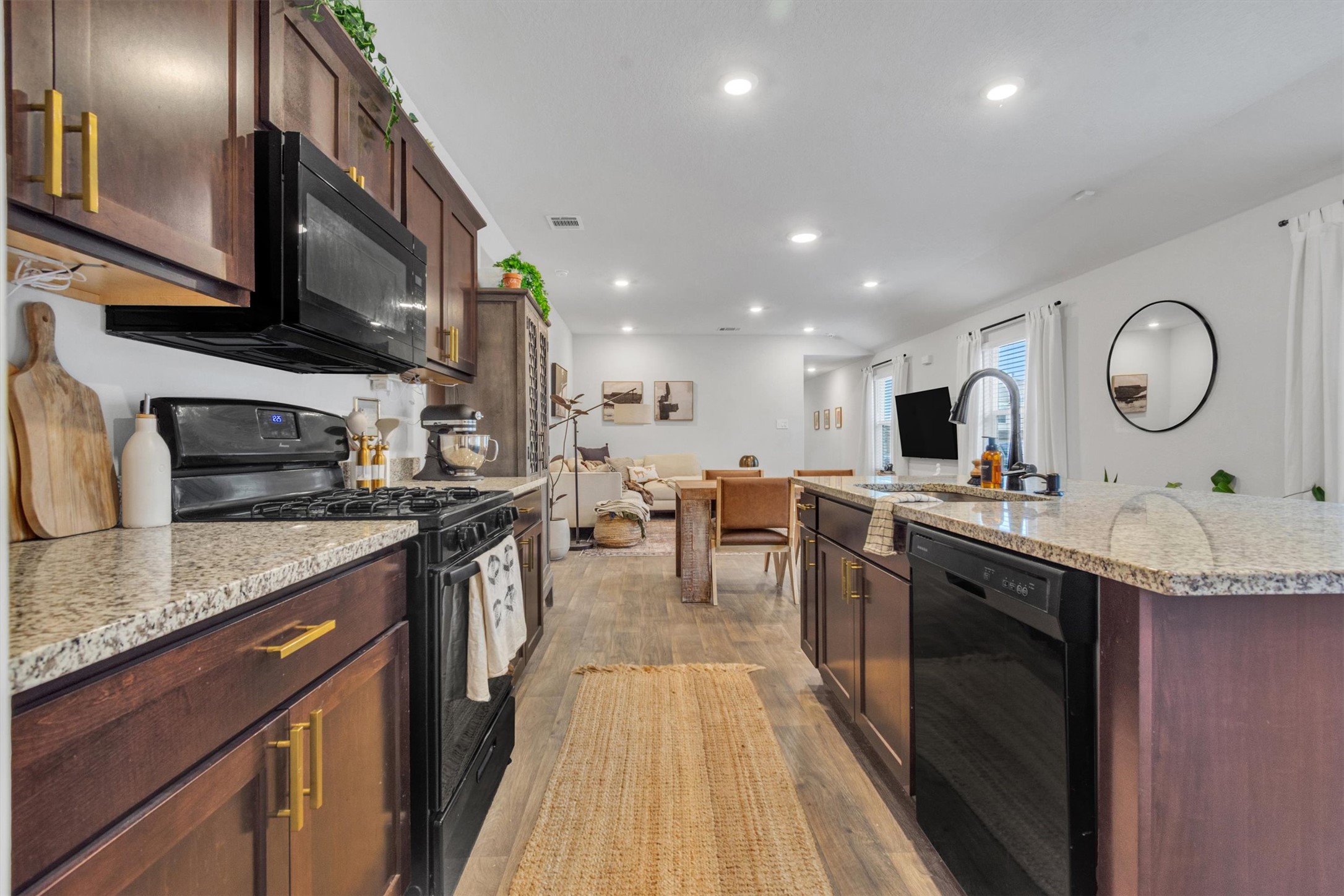 204 Calgary Lane San Marcos, TX 78666 - Photo 8 of 23 Open galley kitchen makes cooking a breeze with plenty of counter space and great spacing of the work triangle.