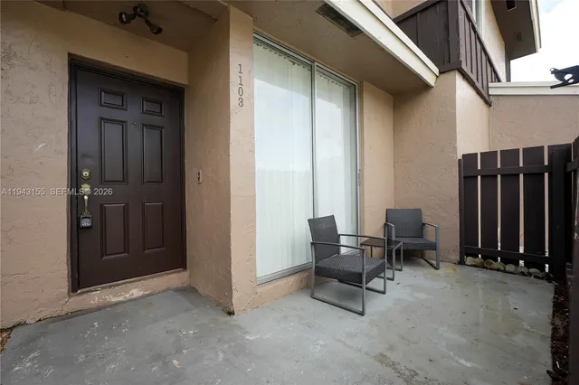 a view of a room with outdoor seating