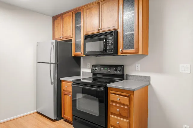 a kitchen with stainless steel appliances granite countertop a stove microwave and refrigerator