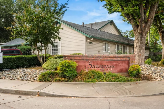 a front view of a house with a garden