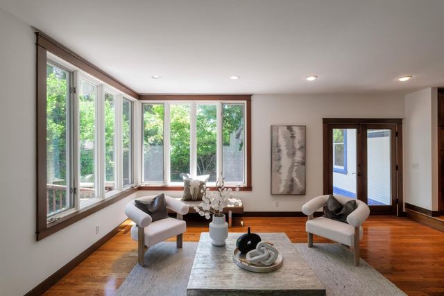 a living room with furniture and floor to ceiling windows