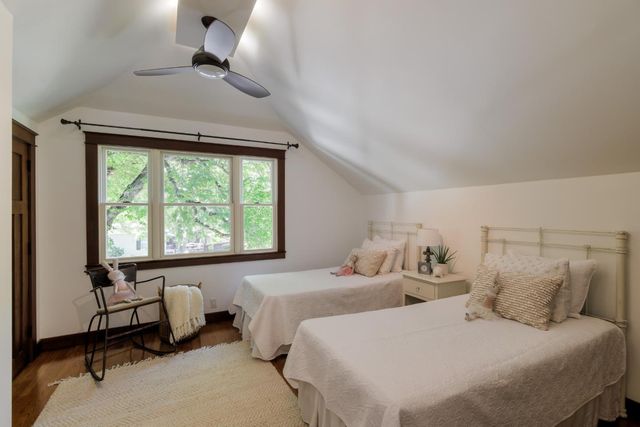 a bedroom with two beds and a large window