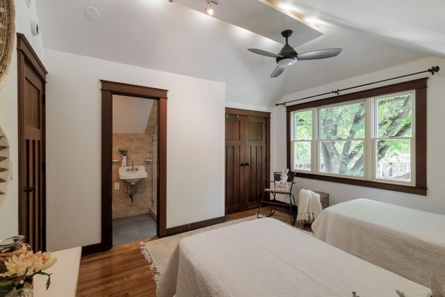 a bedroom with two beds and a large window