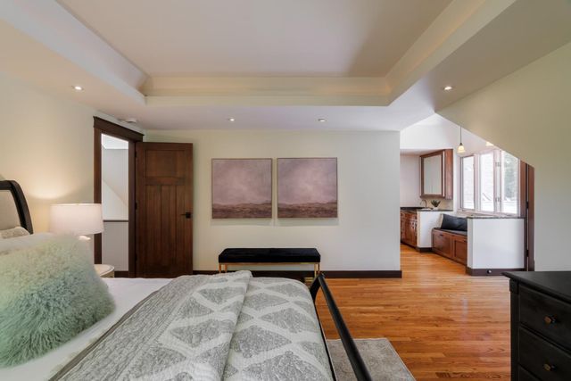 a bedroom with a bed mirror and window