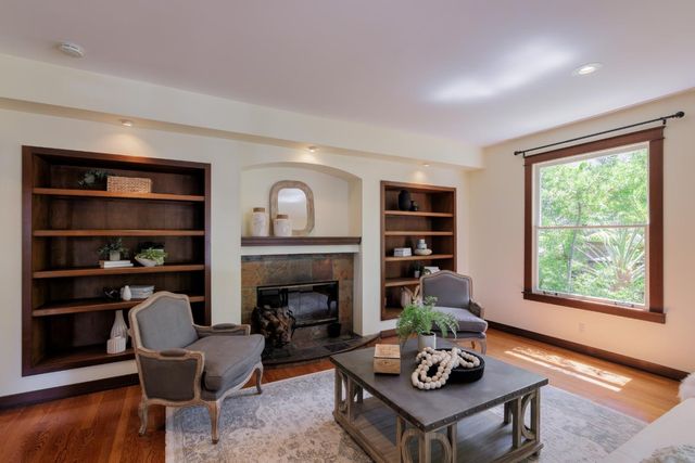 a living room with furniture and a fireplace