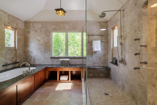 a large bathroom with a bathtub and a sink