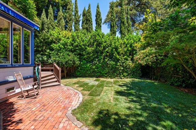 a backyard of a house with yard and outdoor seating