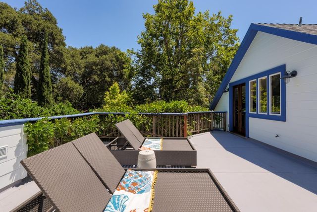 a view of a chair and tables in the balcony