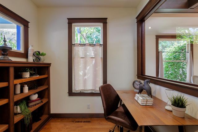 a view of a workspace with furniture and a window