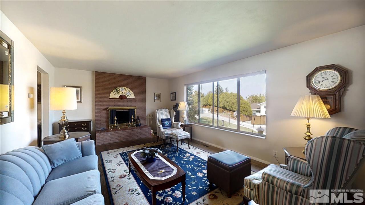 3333 Menlo Court Reno, NV 89509 - Photo 5 of 29 a living room with furniture a fireplace and a table