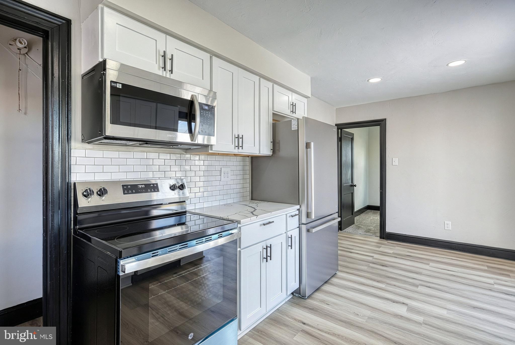 327 Norway Street York, PA 17403 - Photo 26 of 64 a kitchen with stainless steel appliances a stove microwave and sink