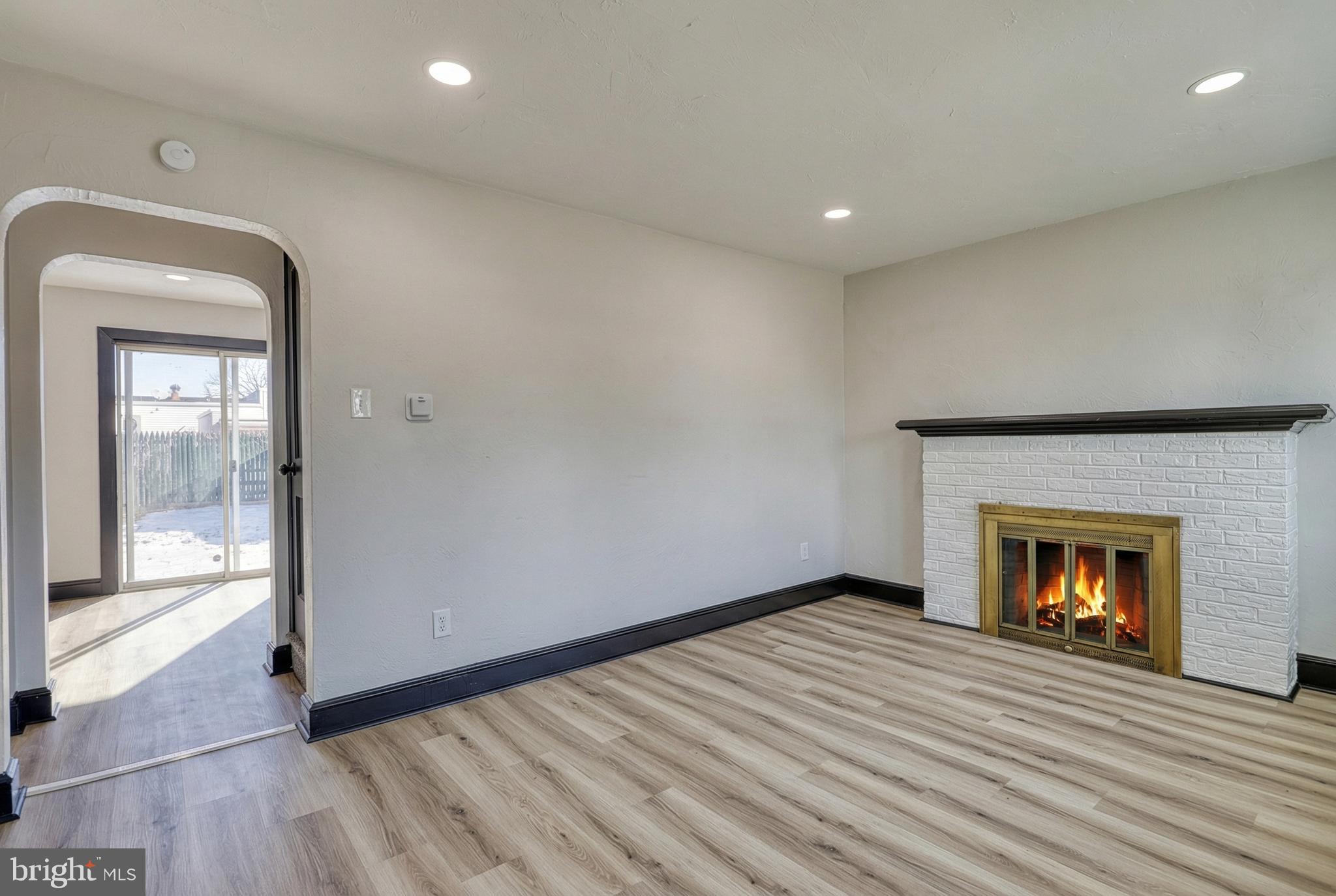 327 Norway Street York, PA 17403 - Photo 7 of 64 an empty room with wooden floor fire place and windows