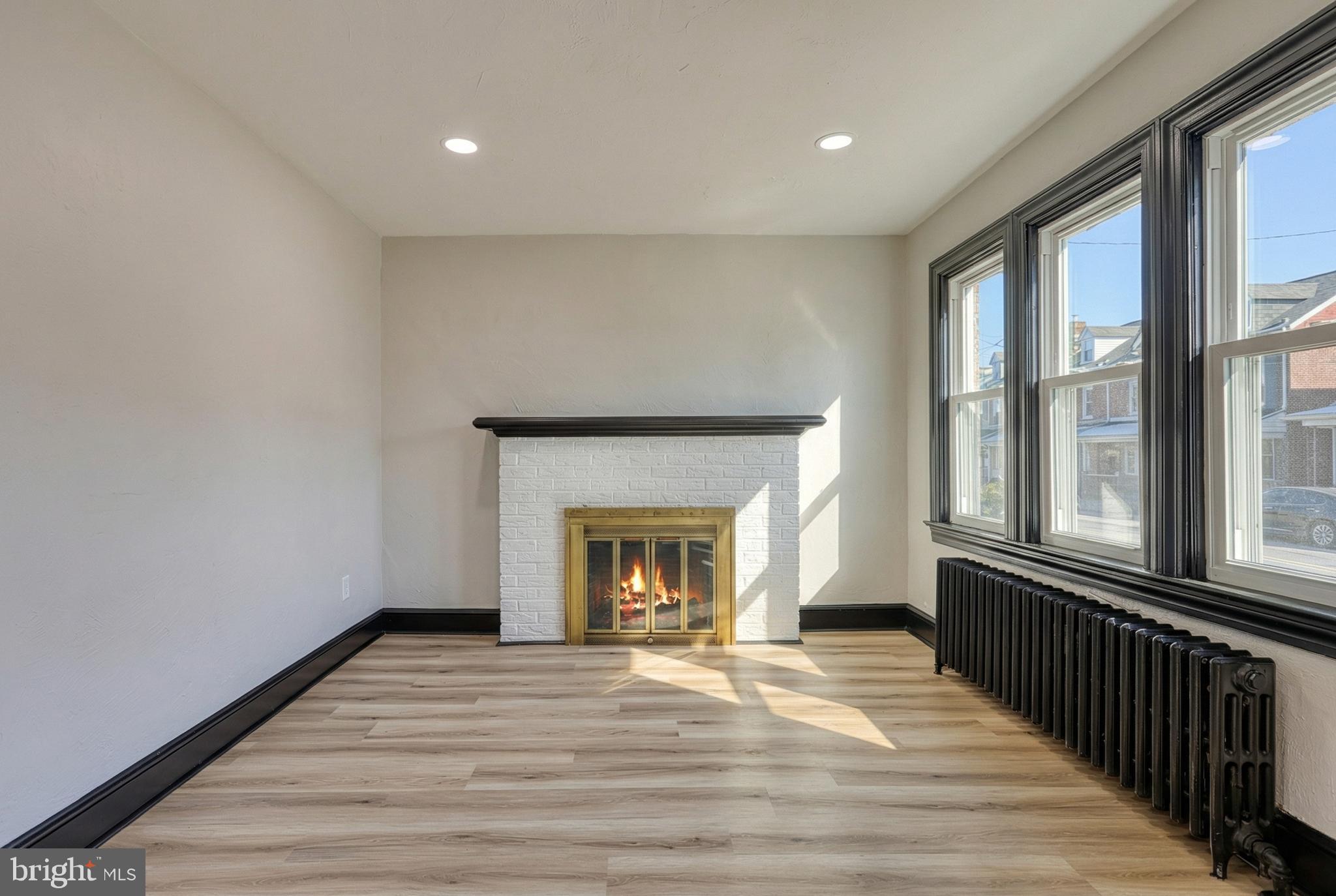 327 Norway Street York, PA 17403 - Photo 8 of 64 wooden floor fireplace and windows in an empty room