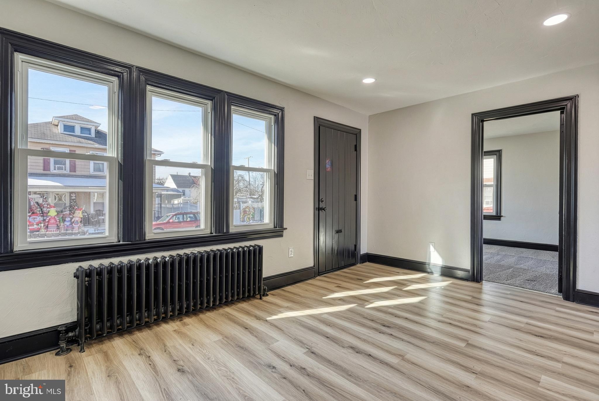 327 Norway Street York, PA 17403 - Photo 10 of 64 a view of an empty room with window and wooden floor