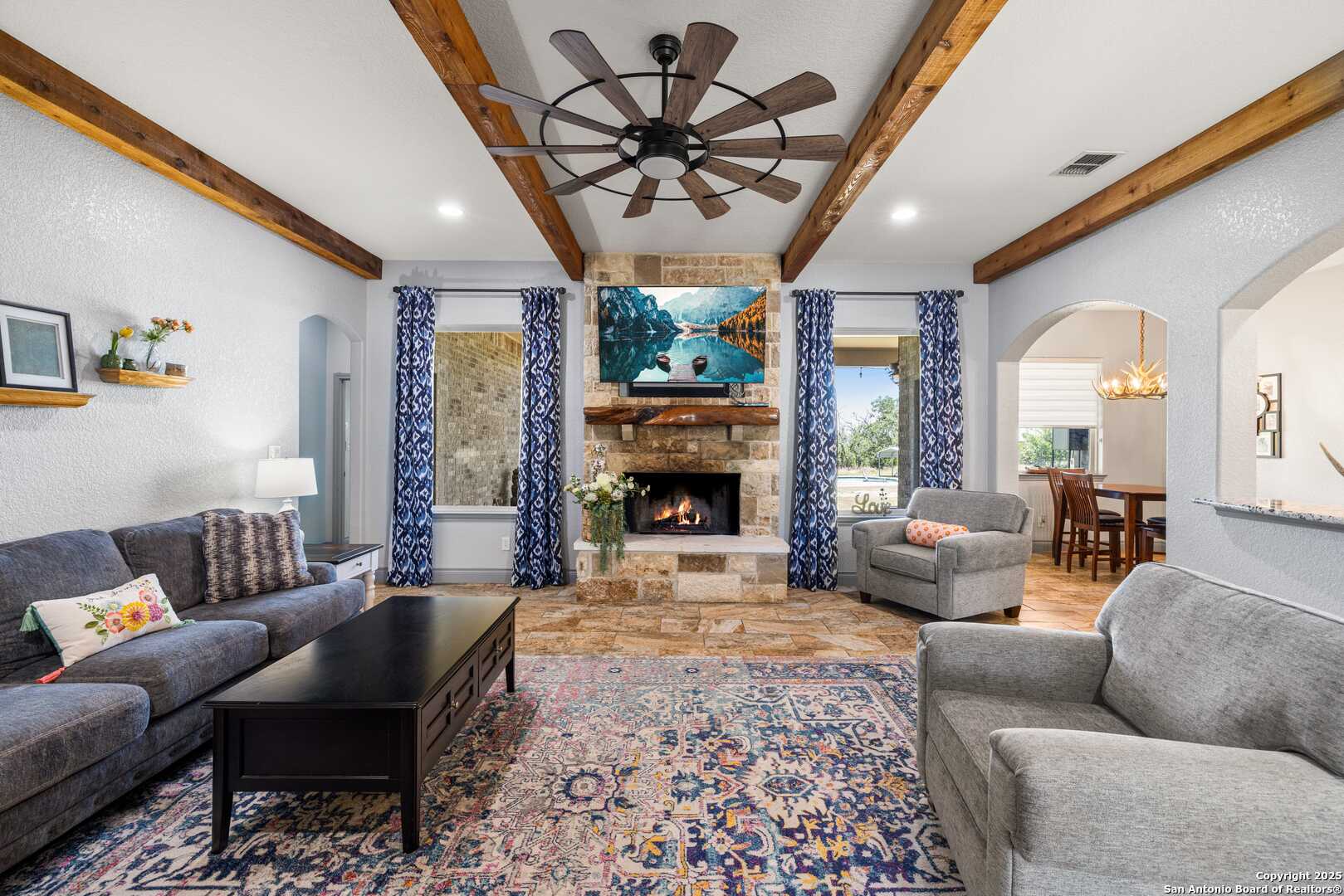 997 Kramer Road Harper, TX 78631 - Photo 12 of 45 a living room with furniture a fireplace and a chandelier