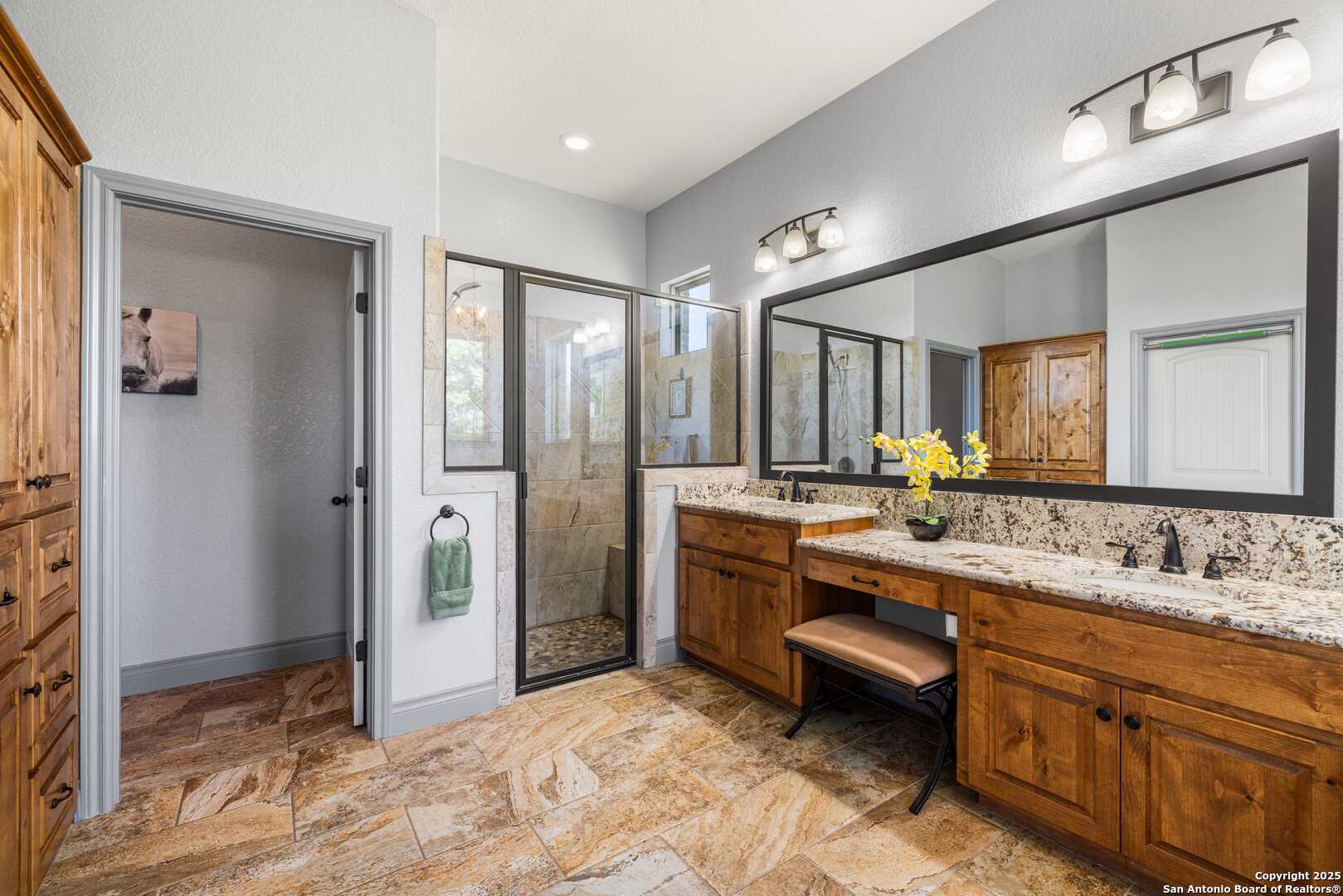 997 Kramer Road Harper, TX 78631 - Photo 20 of 45 a large bathroom with a large mirror vanity and shower