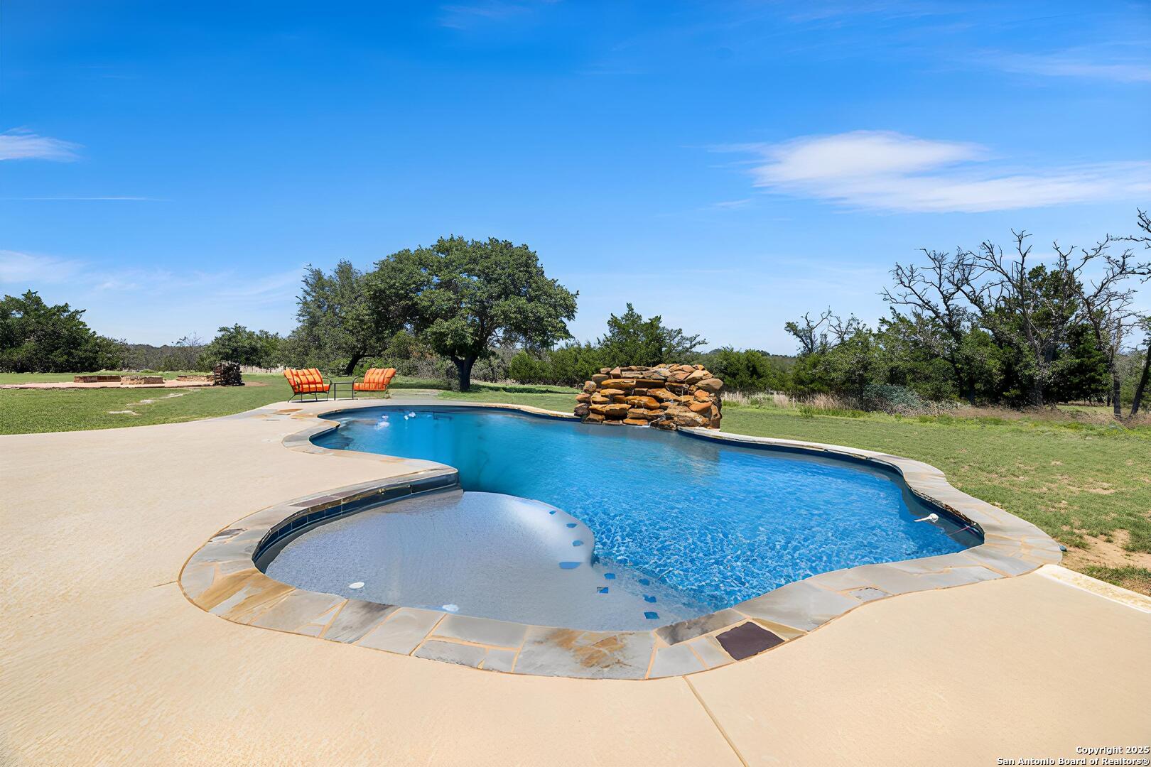 997 Kramer Road Harper, TX 78631 - Photo 32 of 45 a view of a swimming pool and a yard