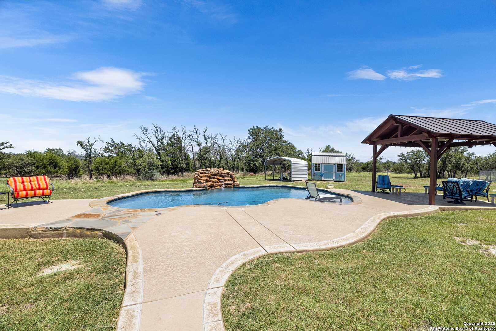 997 Kramer Road Harper, TX 78631 - Photo 33 of 45 a view of a swimming pool and trees in the background