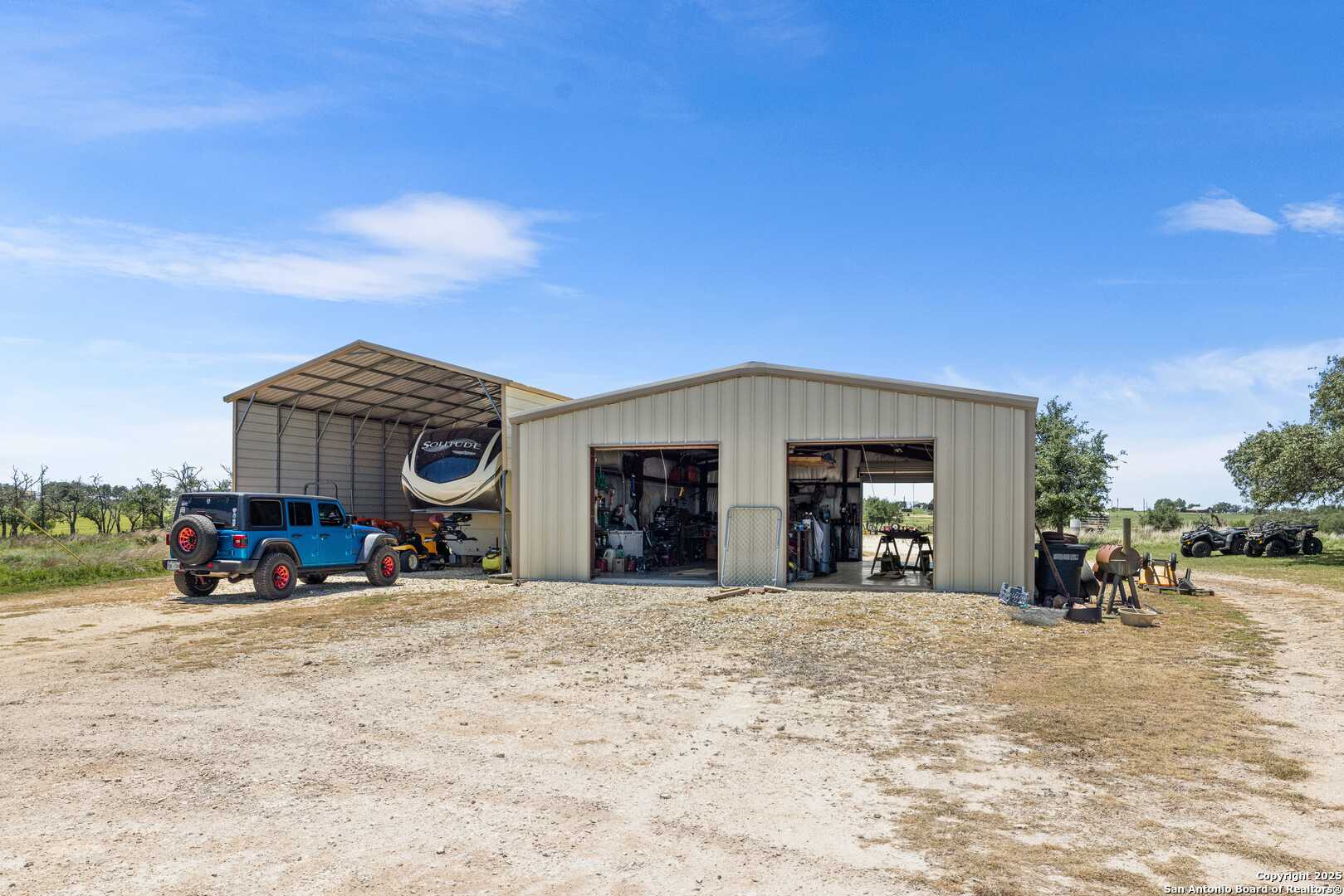 997 Kramer Road Harper, TX 78631 - Photo 9 of 45 a view of a house with large trees in front of it