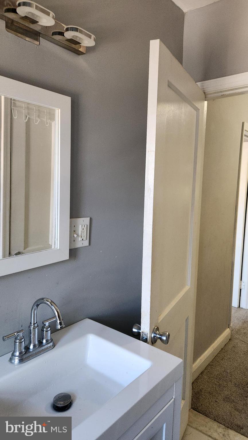 1024 Wicklow Road Baltimore, MD 21229 - Photo 29 of 44 a bathroom with a sink and a mirror