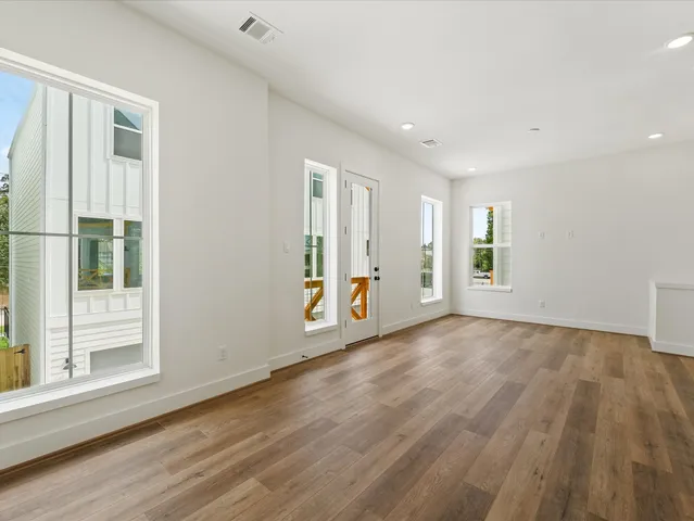 a kitchen with stainless steel appliances granite countertop a sink a oven and wooden floors