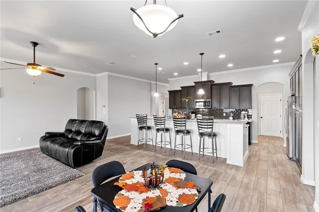 a living room with lots of furniture and kitchen view