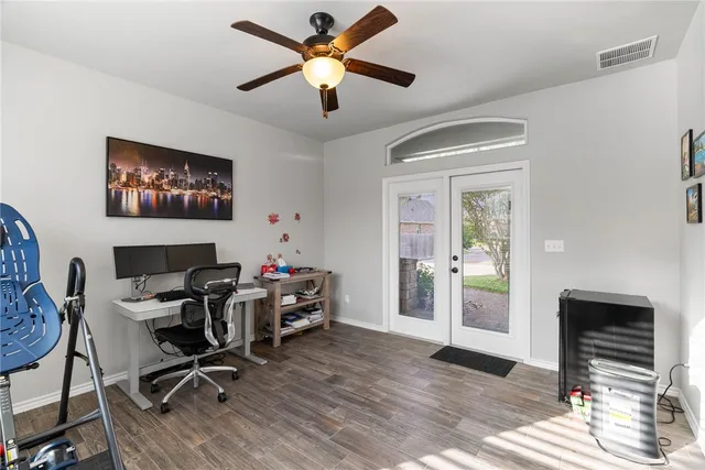 a view of a workspace with furniture and a window
