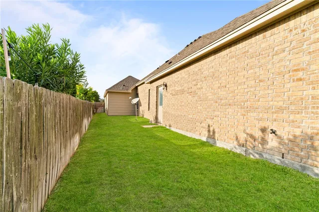 a view of a backyard with wooden fence