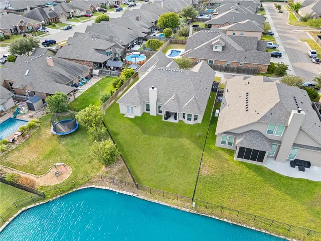 an aerial view of a house with a swimming pool